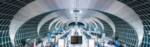 Hall moderne d'aéroport en Thaïlande avec des passagers et des indications pour les options de visa longue durée.