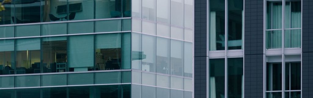 Modern office building with glass facades, symbolizing corporate transparency and the importance of a Company Affidavit in Thailand.