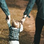 A family walking hand in hand on a dirt path, symbolizing the legal protection and guidance a family lawyer in Thailand can provide.