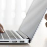 Person submitting a visa application Thailand on a laptop