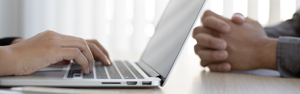 Person submitting a visa application Thailand on a laptop