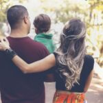 Family holding hands with their child, illustrating the process of obtaining a Thailand DTV visa to move together as a family.