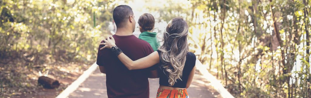 Family holding hands with their child, illustrating the process of obtaining a Thailand DTV visa to move together as a family.