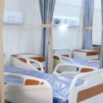 Interior of a modern medical clinic Thailand with patient beds and privacy curtains