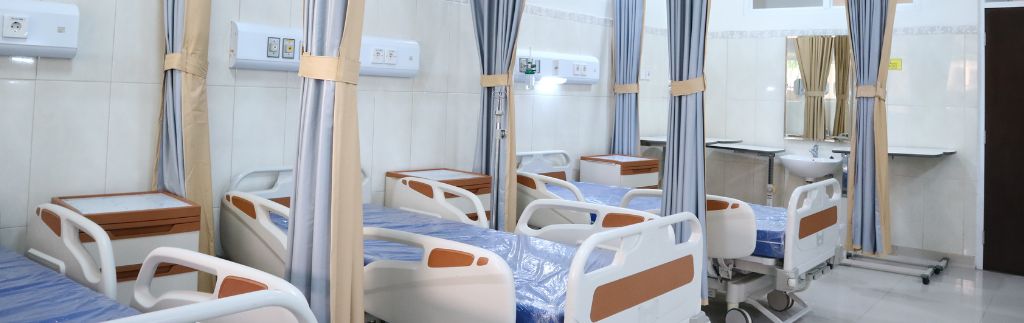 Interior of a modern medical clinic Thailand with patient beds and privacy curtains