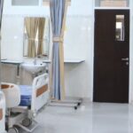 Chambre de soins moderne dans une clinique médicale Thaïlande avec lits équipés et rideaux de confidentialité