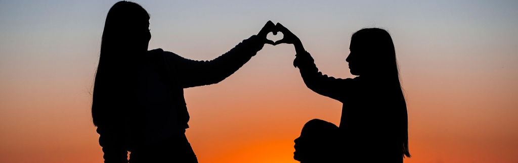 Family Visa in Thailand: Heart-shaped silhouette at sunset.