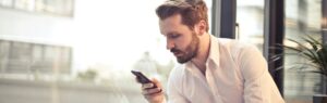 Businessman checking documents on his phone — Thailand Investment Visa