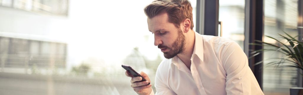 Businessman checking documents on his phone — Thailand Investment Visa