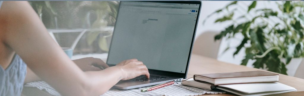 Person typing on laptop researching boi 2025 investment regulations in Thailand