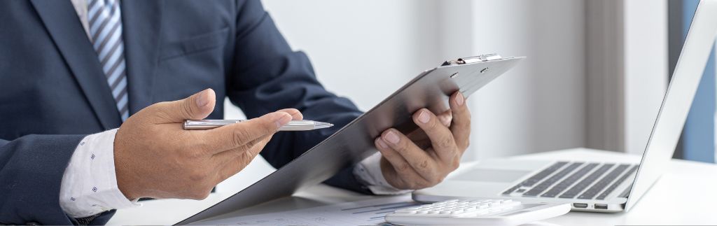 Professional discussing LTR visa BOI benefits with a clipboard and laptop