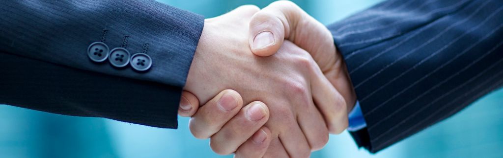 Handshake between business partners representing a Thai partner agreement