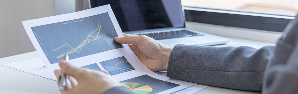 Business person analyzing graphs and charts related to business in Koh Samui.