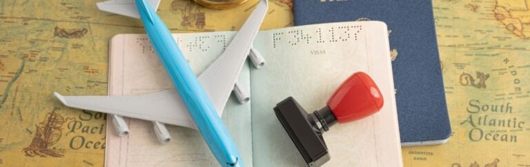 Passeport ouvert avec tampon, avion miniature et carte du monde illustrant le visa affaire Singapour et les voyages d’affaires internationaux