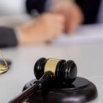 Administrative litigation and appeals in Thailand – judge's gavel and scales of justice on a lawyer's desk