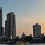 Bangkok skyline at sunset with Chao Phraya River and modern skyscrapers
