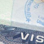 Close-up of a passport with a visa stamp, symbolizing Thailand visa reform.