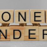 Wooden blocks spelling "MONEY LAUNDERING" with a focus on the importance of Anti Money Laundering in Thailand to prevent illicit financial activities.
