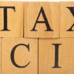 Wooden cubes spelling out "Tax Excise" illustrating the excise tax in Thailand