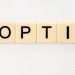 Adozione in Thailandia – parola “adoption” composta con lettere su sfondo chiaro, simbolo del processo di adozione internazionale in Thailandia.