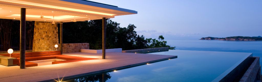 Luxury modern villa with infinity pool overlooking the ocean at sunset in Phuket, ideal for investors buying villa through company in Phuket.